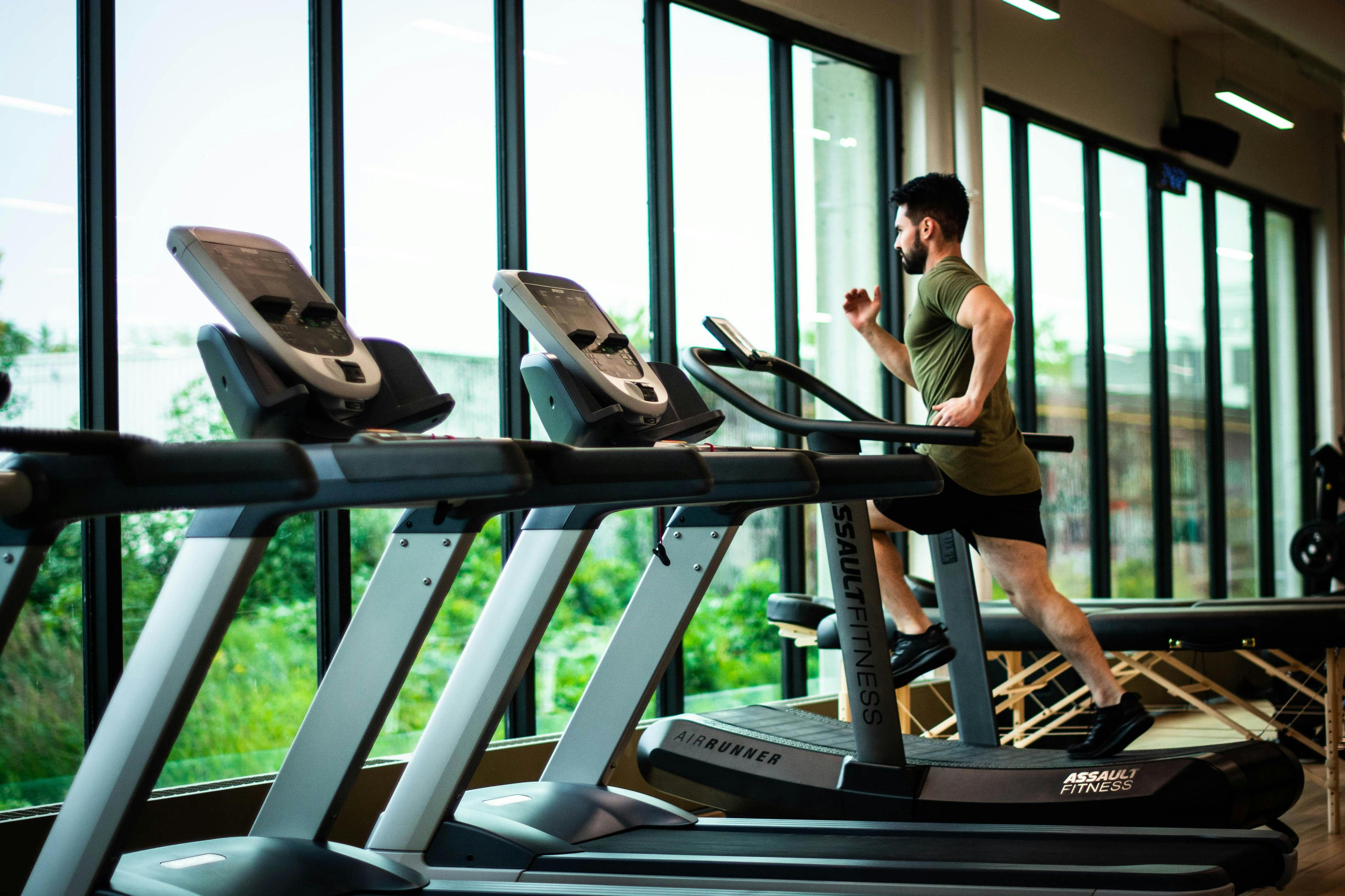 Modern fitness center interior with exercise equipment and active members